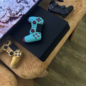 Sony PlayStation 4 Console with Blue and Black Controllers